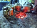 Old mud chulha with tea kettle and fire.