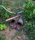 Old muddy shoes and garden hoe in the hobby garden Royalty Free Stock Photo