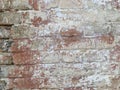 Background of old vintage dirty brick wall with peeling plaster, texture. Old multi colored brick wall Royalty Free Stock Photo