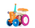 Old multicolored plastic toy tractor constructor, isolated on white background. File contains a path to isolation. Royalty Free Stock Photo