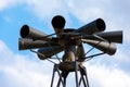 Old multidirectional emergency siren attached to a steel pylon