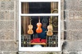 Old musical instruments in the window of a second-hand and antiques shop in the village of Falkland in Scotland
