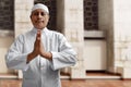 Old muslim man smiling inside mosque