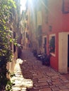 Old narrow street in Rovinj Croatia Istria with a morning sun ray Royalty Free Stock Photo