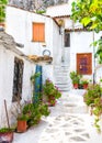 Old narrow street with flowers in Anafiotika, Plaka district, Athens, Greece. Plaka is tourist attraction of Athens