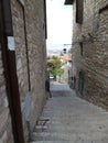 An old narrow street in the medieval town of Assisi. Italy, August 2012