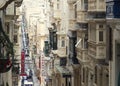 Old Narrow Street With Traditional Closed Wooden Balconies In Valletta