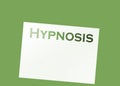Word Hypnosis typed on the top of a blank page put on a green background