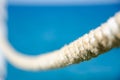 Old nautical cord. Sea background with copy space. Selective focus on rope texture on blurred sea surface background. Stretched Royalty Free Stock Photo