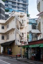 Old neglected white and blue buildings in Little India District in Singapore with spiral staircases and worn out paint