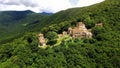 Old Nekresi monastery in green trees, sightseeing Georgia aerial view, religion