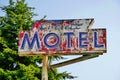 Old Neon Painted Motel Sign with Arrow on Tall Metal Pole Royalty Free Stock Photo