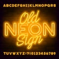 Old Neon Sign alphabet font. Yellow neon light letters and numbers on brick wall background.