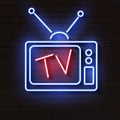 Old neon TV with antenna on brick wall Royalty Free Stock Photo