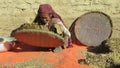 Old Nepalese lady sifting chickpeas