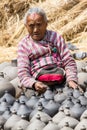 Old Nepalese woman working with pottery