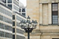 Old and new Berlin at Gendarmenmakt, old street lanterns in front of classical and new buildings Royalty Free Stock Photo