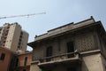 Old and new. construction of a new residential building on the background of historical housing. milan, italy, europe. an old hous Royalty Free Stock Photo