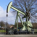 Old and new energy. A nodding donkey and a wind turbine Royalty Free Stock Photo