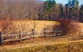 Old New England tongue and groove split rail fence along a trail  in a field Royalty Free Stock Photo