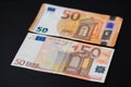 Old and new 50, fifty Euro banknotes on dark background. European monetary union. Design of Euro cash Banknotes. EU currency Euro Royalty Free Stock Photo