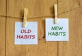 Old or new habits symbol. Wooden clothespins with white sheets of paper. Words `old habits, new habits`. Beautiful wooden Royalty Free Stock Photo
