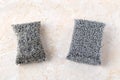 Old and new silver foam sponges for dishwashing on a kithen table. Metallized fiber foam sponge for dishes and housework. Purity