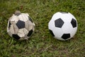 Old and new soccer ball Football on green grass Royalty Free Stock Photo