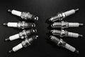 Old and New Spark plugs on black background . car and motorcycle part. The concept of car service, repair. Top down view. Black Royalty Free Stock Photo
