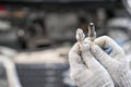 Old and new spark plugs. Comparing spark plugs the maintenance of the engine, on the hands of a mechanic. Royalty Free Stock Photo