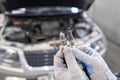 Old and new spark plugs. Comparing spark plugs the maintenance of the engine, on the hands of a mechanic. Royalty Free Stock Photo