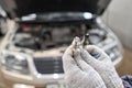 Old and new spark plugs. Comparing spark plugs the maintenance of the engine, on the hands of a mechanic. Royalty Free Stock Photo