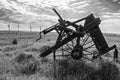 Old and new technology - wind turbines and abandoned plough - black and white Royalty Free Stock Photo