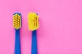 Old and new toothbrush in contrast on pink background Royalty Free Stock Photo