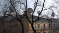 Old and new. View of the roof of an old mansion with many satellite dishes. Royalty Free Stock Photo