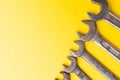 Old dirty wrenches on a yellow background. From above. Copy space Royalty Free Stock Photo