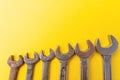 Old dirty wrenches on a yellow background. From above. Copy space Royalty Free Stock Photo