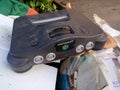 Old Nintendo 64 in a pile of trash Royalty Free Stock Photo