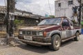 An old Nissan pickup truck is rusty and ancient on the street in Thailand. Takua Pa Thailand, Phang Nga March 2, 2023.