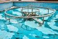 Old non-working abandoned fountain pipes. Empty pool. Turned off fountain in a park