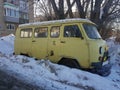 Old non-working car in the snow under a tree Royalty Free Stock Photo