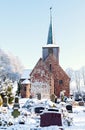 Old North German church with cemetery in winter in Geestland