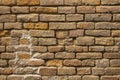 A old not neat red brick wall. rough surface texture. heavily damaged brickwork Royalty Free Stock Photo