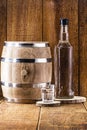 Old oak barrel and glass of high quality distilled alcohol. Brazilian silver cachaÃÂ§a, called pinga, vodka, white rum, liqueur,