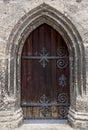 Old oak door at ancient stone cathedral Royalty Free Stock Photo