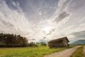 Old oblique wooden shed house in meadow Royalty Free Stock Photo