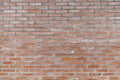 Old obsolete orange brick wall with gray cement stained background texture nobody Royalty Free Stock Photo