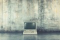 Old and obsolete personal computer set on the floor against a concrete wall Royalty Free Stock Photo