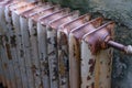 Old obsolete rusty radiator. The problem of winter house heating.