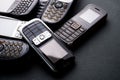 Old and obsoleted cellphones on black background Royalty Free Stock Photo